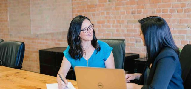 Two women meeting in an office space.